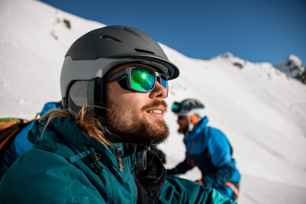 Skiers and snowboarder wearing winter sunglasses to protect their eyes