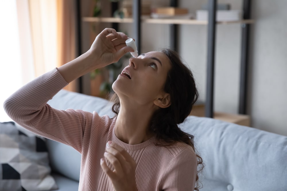 A woman using eye drops, one of the most popular means to treat allergy eyes