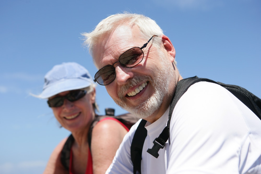 elderly couple wearing polarized sunglasses while on vacation somewhere sunny