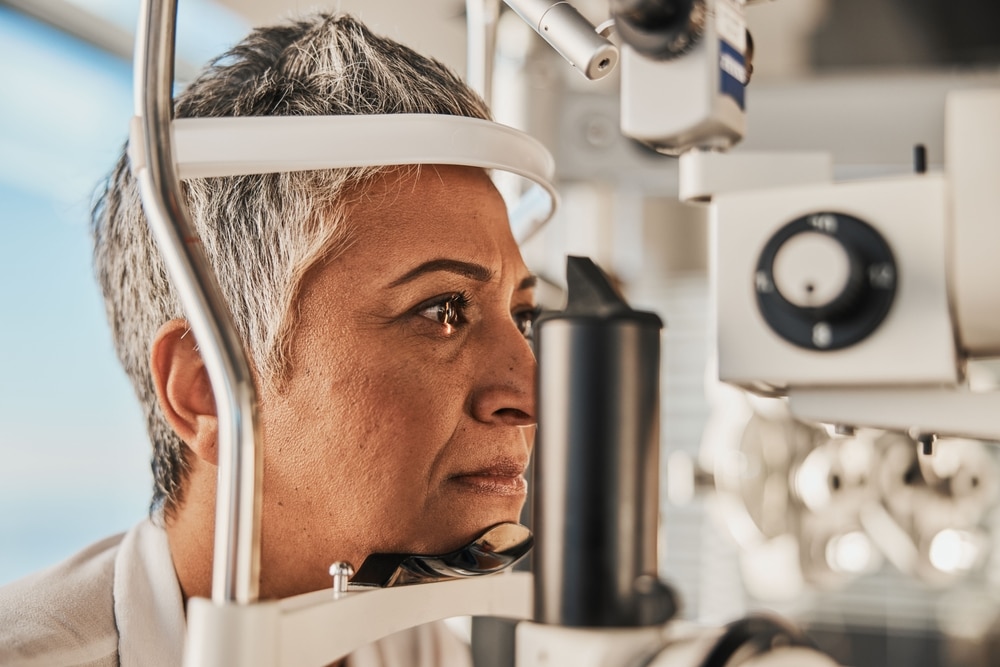 Senior woman getting an eye exam - one of the many factors in overall eye health