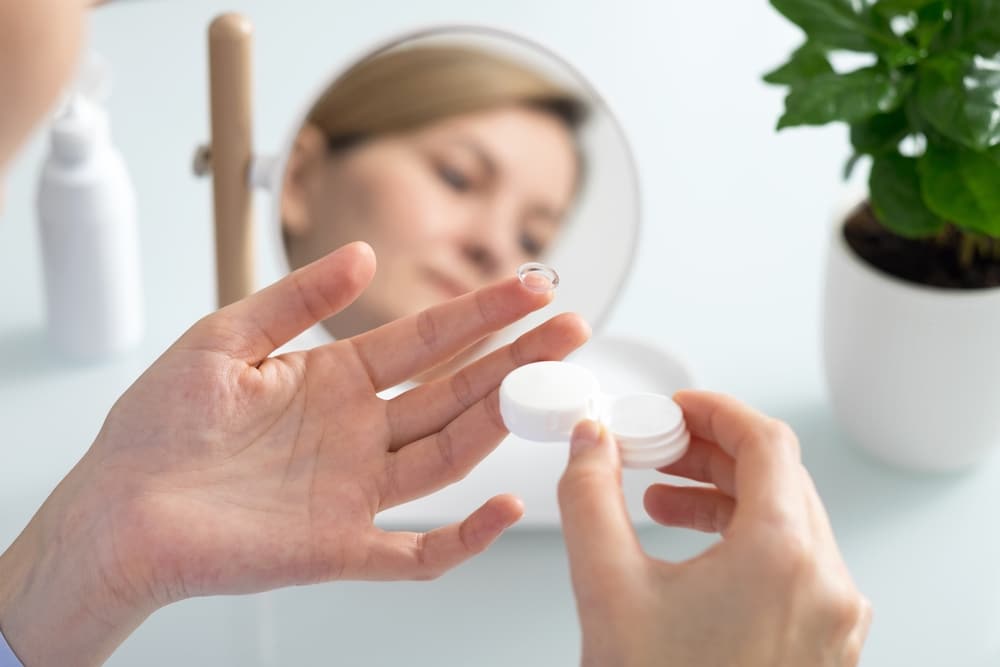 Woman getting ready to put in her contacts - a form of corrective lenses